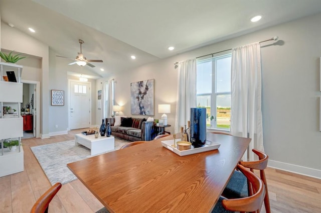 dining room with recessed lighting, vaulted ceiling, light wood-style flooring, and baseboards