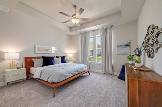 111 Pinnacle Ln Unit A, Kyle, TX 78640 - bedroom with baseboards, a raised ceiling, visible vents, and light carpet