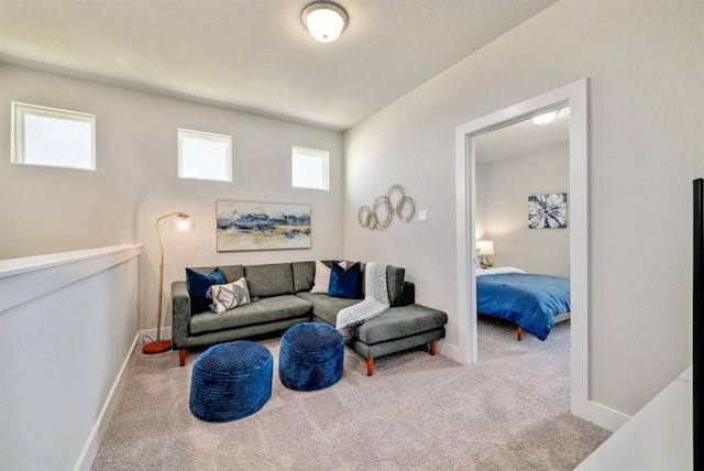 carpeted living area featuring baseboards