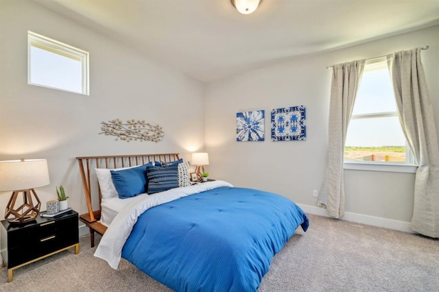 carpeted bedroom featuring baseboards