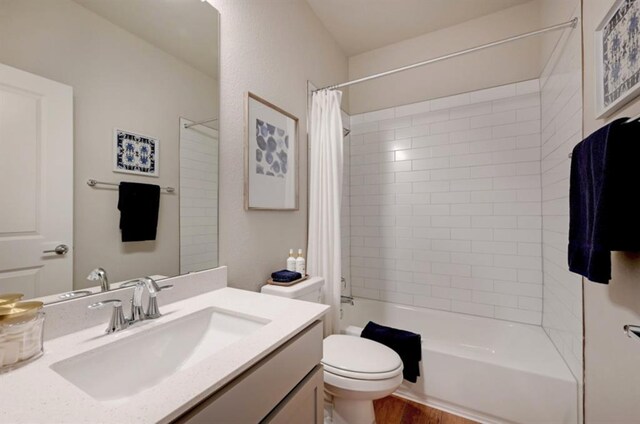 111 Pinnacle Ln Unit A, Kyle, TX 78640 - bathroom featuring vanity, shower / bathtub combination with curtain, wood finished floors, and toilet