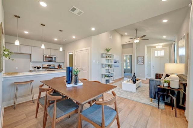 dining space featuring lofted ceiling, recessed lighting, visible vents, and light wood-style floors