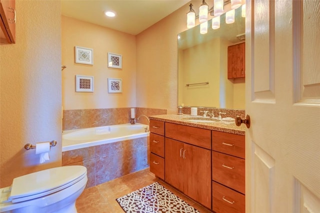 bathroom featuring toilet, tile patterned flooring, a garden tub, and vanity