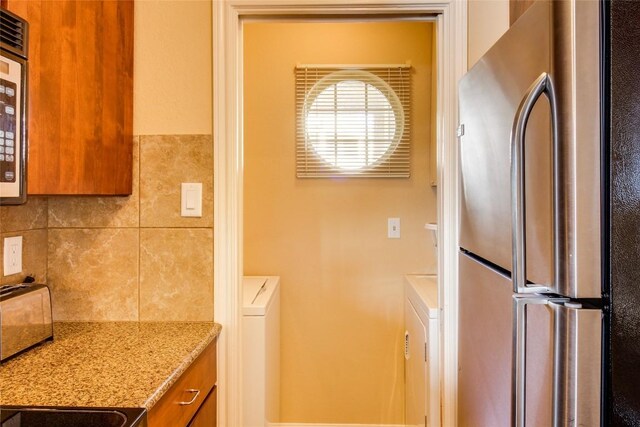 clothes washing area with laundry area and a toaster