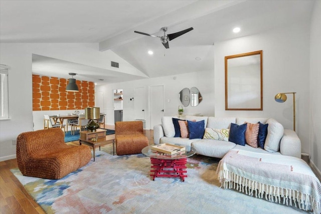 living area featuring visible vents, ceiling fan, wood finished floors, vaulted ceiling with beams, and recessed lighting