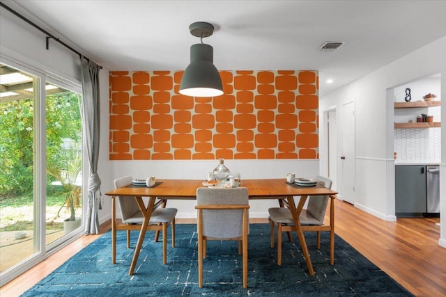 dining room with visible vents and wood finished floors