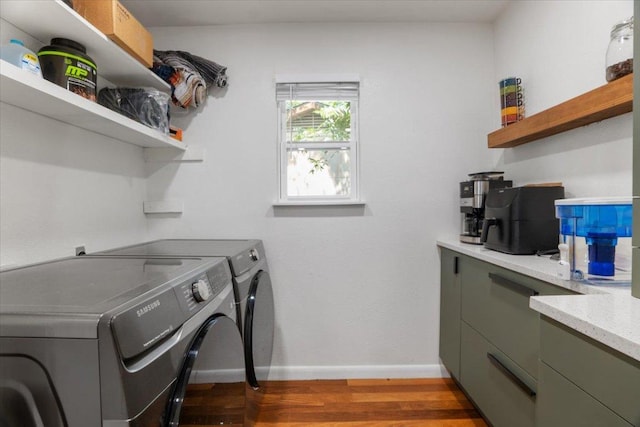 washroom featuring cabinet space, independent washer and dryer, light wood-style flooring, and baseboards