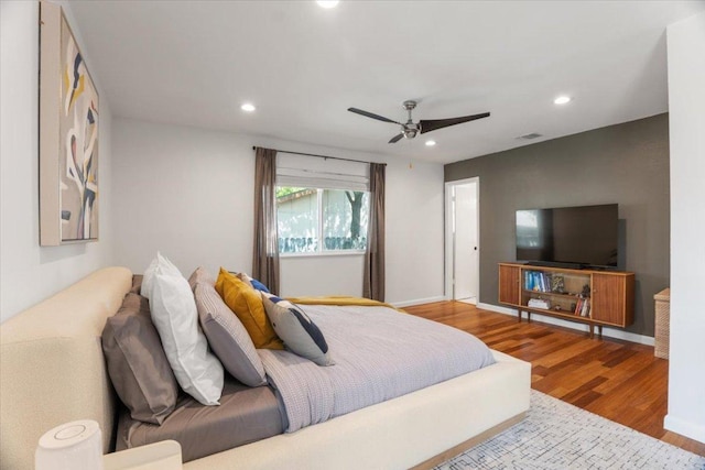 bedroom with a ceiling fan, recessed lighting, baseboards, and wood finished floors