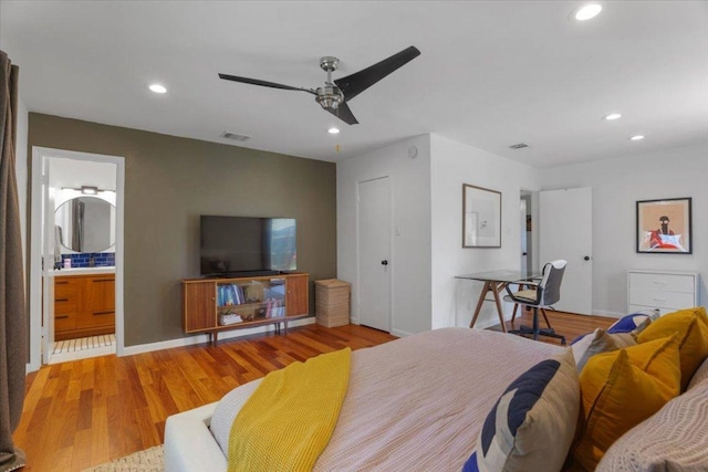 bedroom with recessed lighting, visible vents, baseboards, and wood finished floors