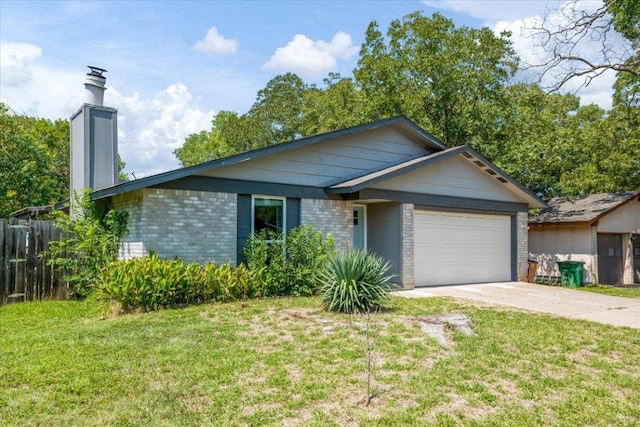 ranch-style home with a front yard, brick siding, driveway, and a chimney