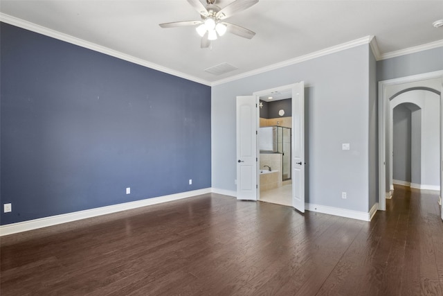 interior space featuring a ceiling fan, wood finished floors, baseboards, arched walkways, and ornamental molding