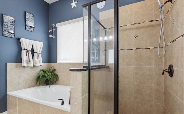 full bathroom featuring a bath and a shower stall