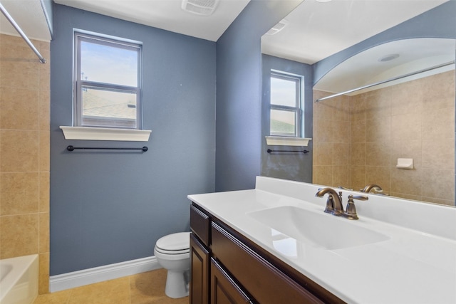 bathroom featuring vanity, baseboards, visible vents, tile patterned floors, and toilet