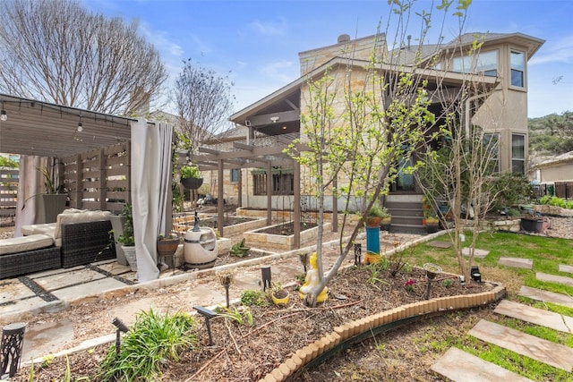 rear view of property with a garden and a pergola