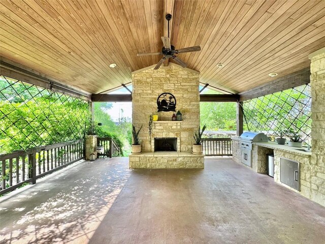 606 Anfield Cir, Austin, TX 78738 - view of patio / terrace with an outdoor stone fireplace, exterior kitchen, and a ceiling fan