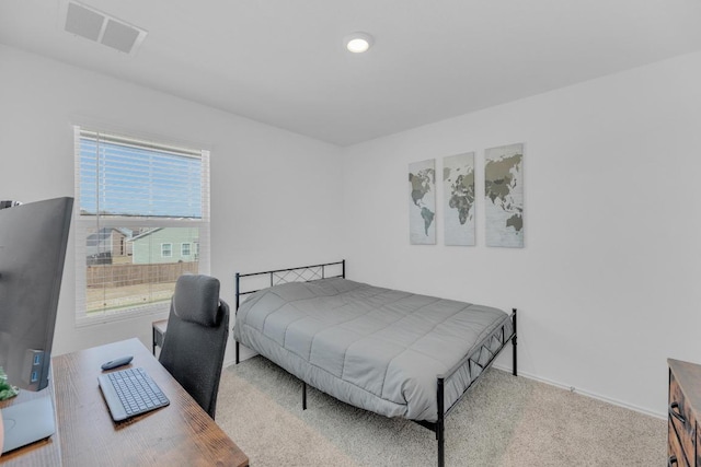 carpeted bedroom with baseboards and visible vents