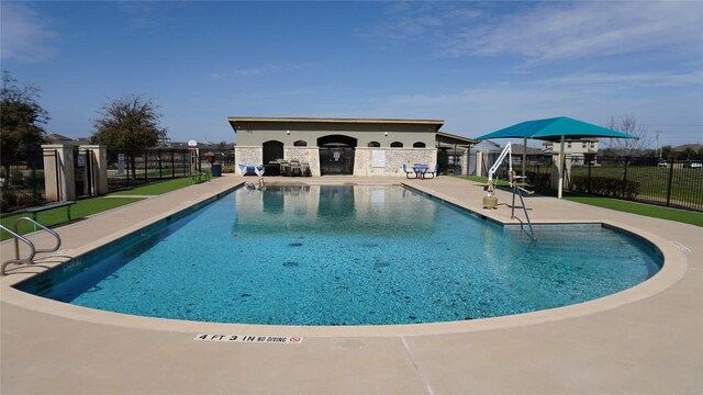 community pool featuring a patio area and fence