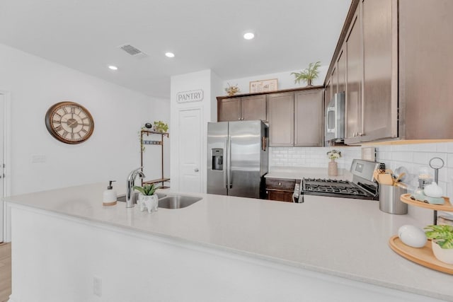 kitchen with visible vents, appliances with stainless steel finishes, light countertops, and a sink