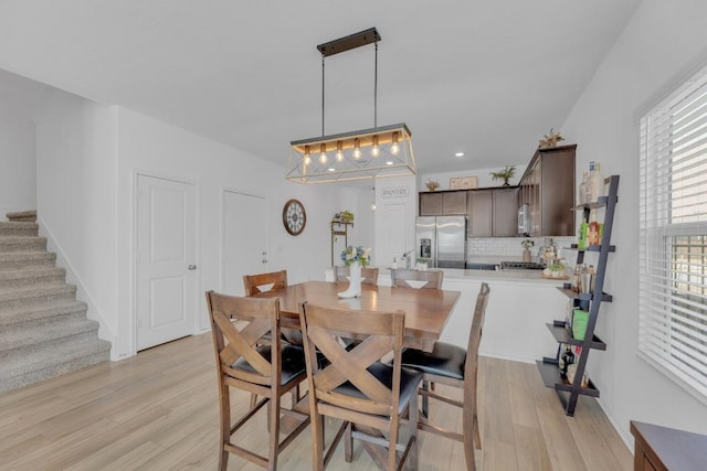 dining room featuring stairway, light wood-type flooring, and recessed lighting