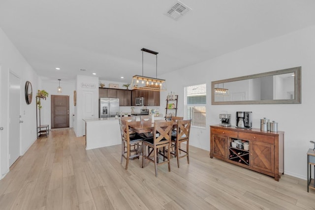 dining space featuring light wood-style flooring, visible vents, and recessed lighting