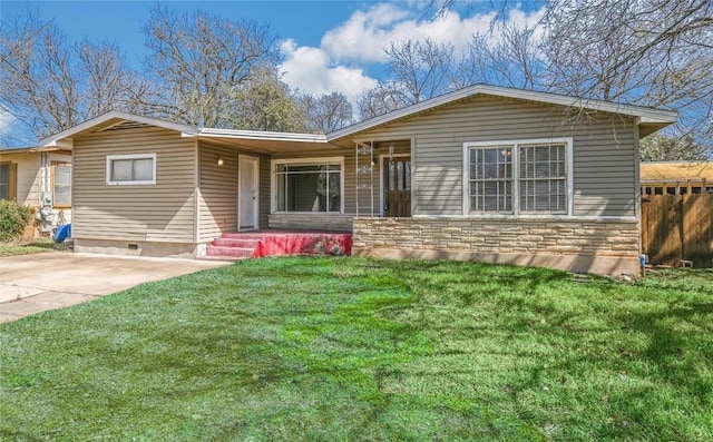 ranch-style house with stone siding, a front yard, and fence