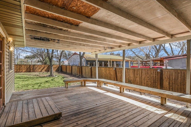 wooden terrace with a fenced backyard and a lawn