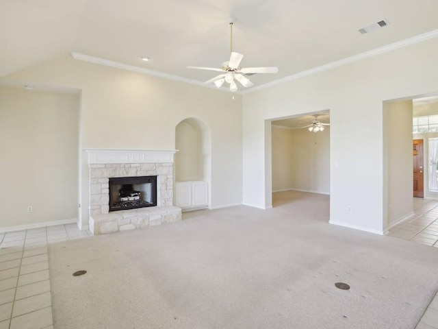 unfurnished living room featuring ceiling fan, light tile patterned floors, a stone fireplace, visible vents, and crown molding