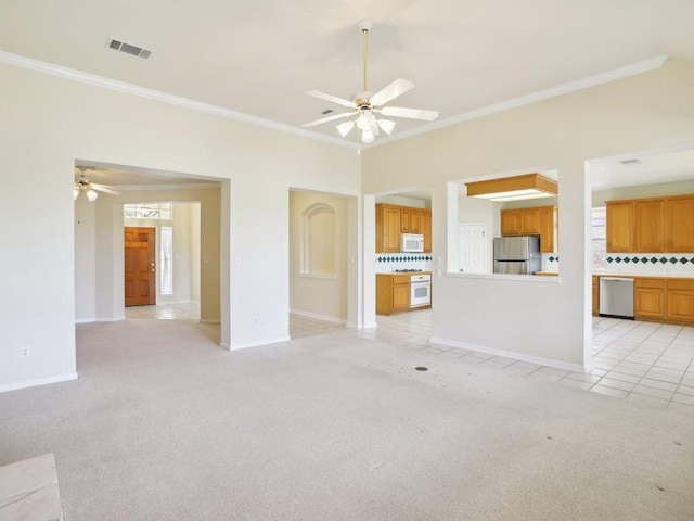 unfurnished living room featuring a ceiling fan, visible vents, crown molding, and light colored carpet