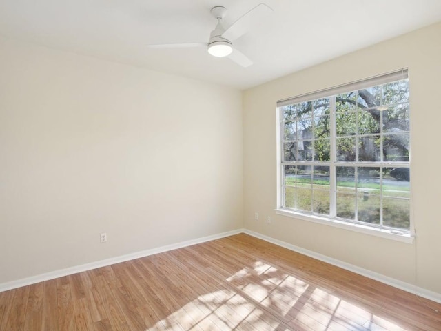 empty room with light wood-type flooring, ceiling fan, and baseboards