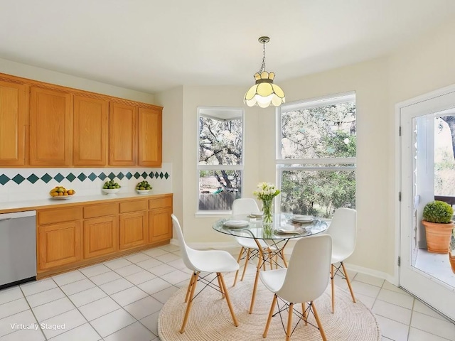 dining space with light tile patterned flooring and baseboards