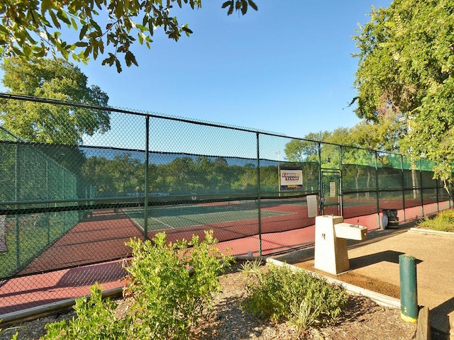 view of tennis court featuring fence