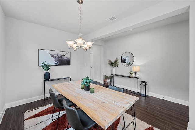 dining area featuring a notable chandelier, baseboards, visible vents, and dark wood-style flooring