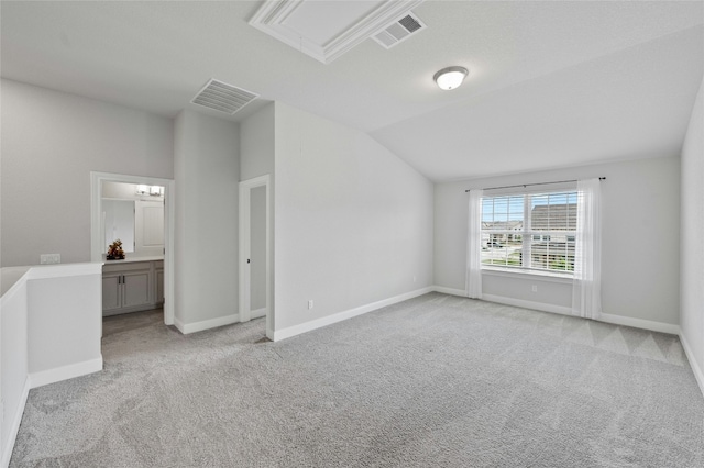 interior space with attic access, visible vents, and light carpet