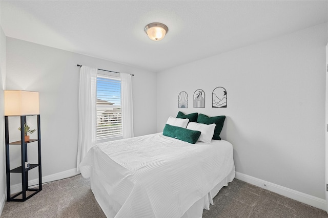 carpeted bedroom featuring baseboards