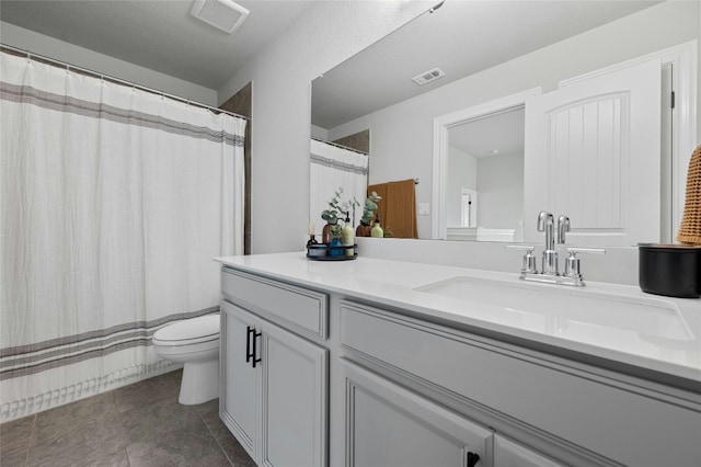 bathroom featuring toilet, tile patterned flooring, visible vents, and vanity