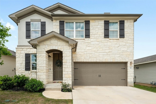 view of front facade featuring a garage, concrete driveway, and stucco siding