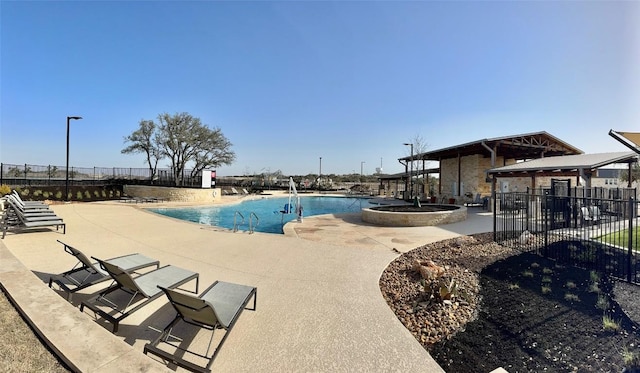 pool featuring fence and a patio