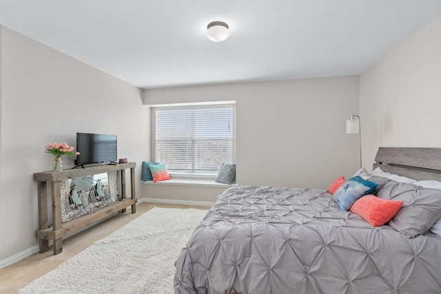 carpeted bedroom featuring baseboards