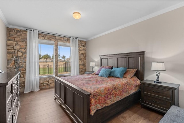 bedroom featuring dark wood-style floors, access to exterior, and crown molding