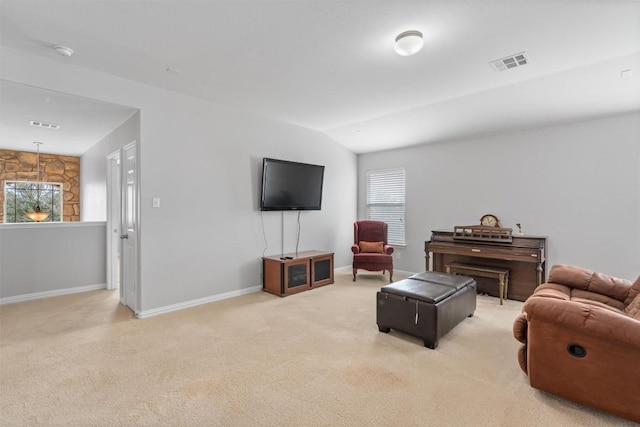 carpeted living room featuring lofted ceiling, baseboards, and visible vents