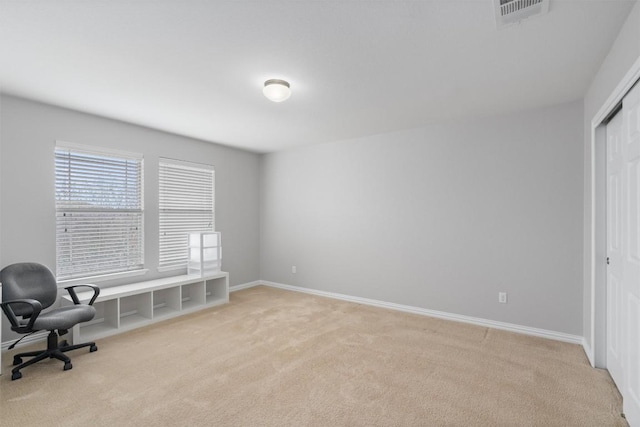 office featuring baseboards, visible vents, and light colored carpet