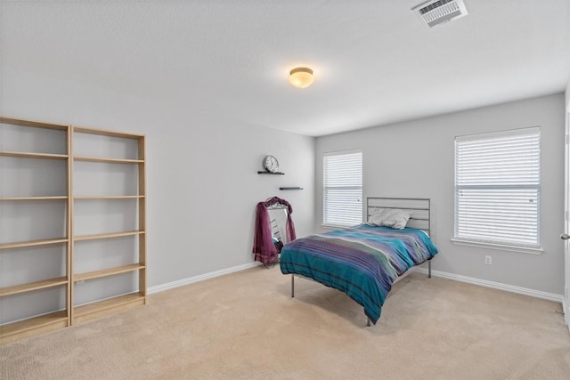 bedroom featuring carpet flooring, visible vents, and baseboards