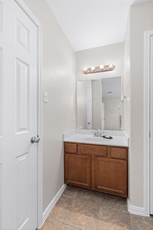 bathroom with vanity and baseboards