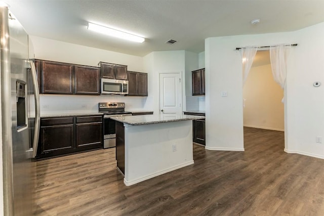 kitchen featuring dark brown cabinetry, visible vents, appliances with stainless steel finishes, and dark wood-type flooring