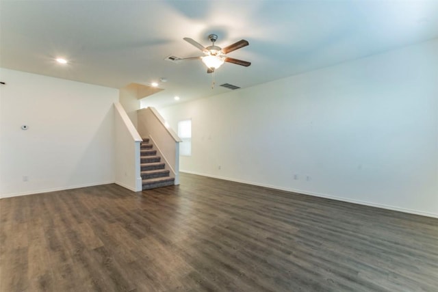 interior space with stairs, dark wood-type flooring, a ceiling fan, and baseboards