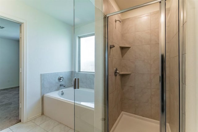 bathroom with a stall shower, tile patterned flooring, visible vents, and a bath