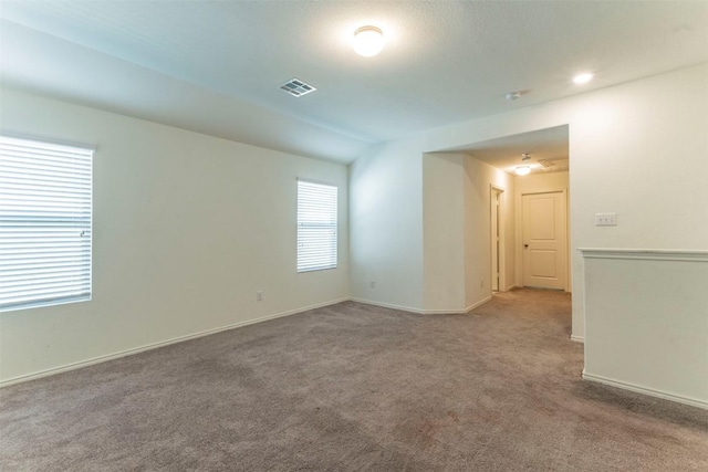 carpeted empty room with visible vents and baseboards