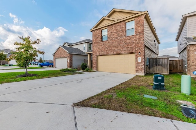 traditional-style home with brick siding, an attached garage, fence, driveway, and a front lawn