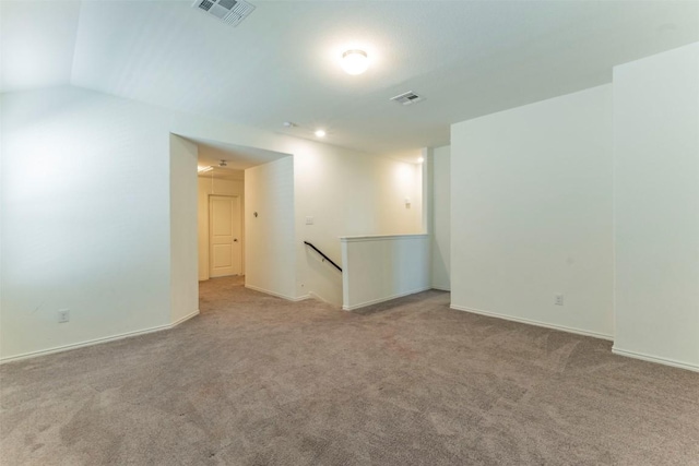 empty room with baseboards, visible vents, and carpet flooring