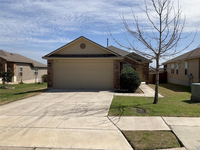 view of front of property with a front yard, brick siding, driveway, and an attached garage